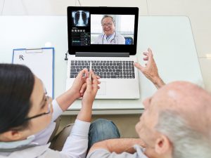Online consultation Senior man and his doctor having video conference with experienced medical worker