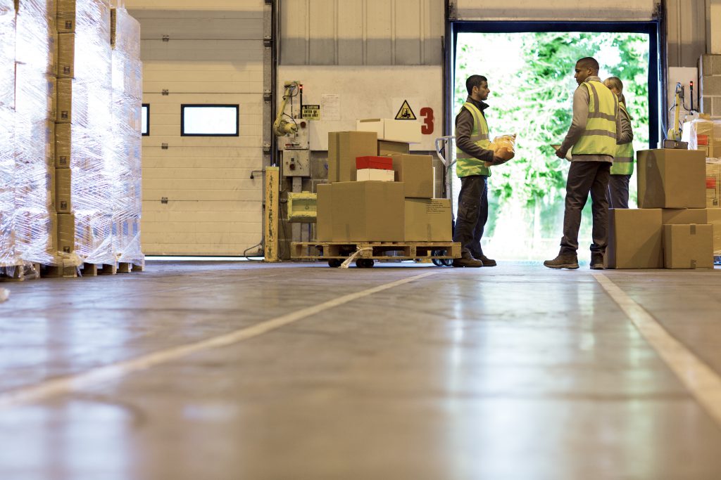 Workers talking in warehouse Workers talking in warehouse